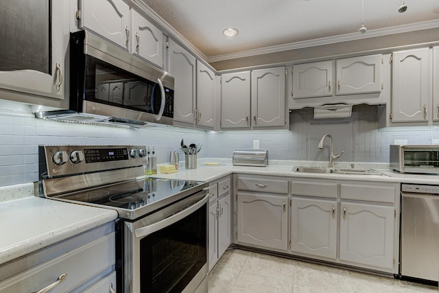 3120 Caledonia Rd, Memphis, TN 38119 - kitchen with stainless steel appliances, a sink, crown molding, gray cabinetry, and backsplash