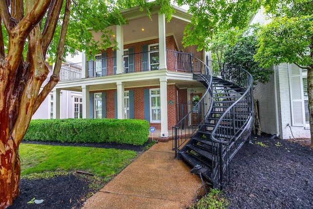 1060 Island Dr, Memphis, TN 38103 - view of front of home with brick siding, stairway, a porch, and a balcony