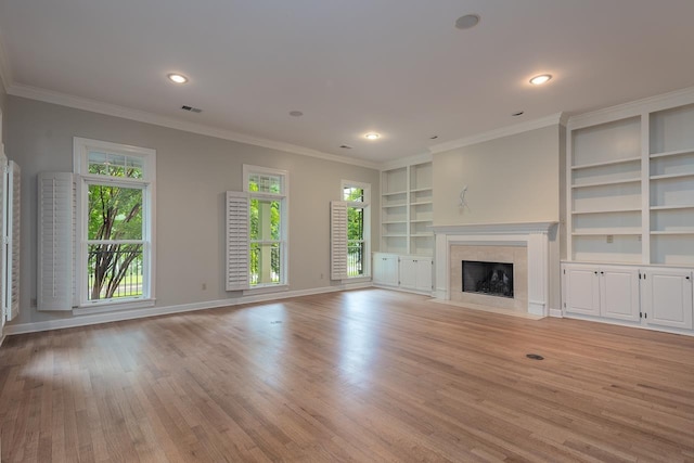 1060 Island Dr, Memphis, TN 38103 - unfurnished living room featuring light wood finished floors, a high end fireplace, built in features, baseboards, and ornamental molding