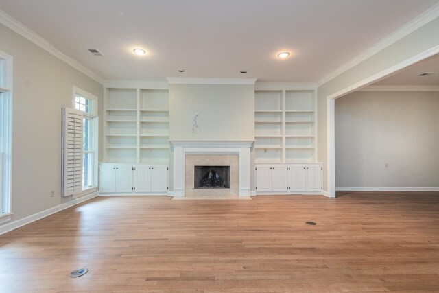 1060 Island Dr, Memphis, TN 38103 - unfurnished living room featuring built in features, crown molding, light wood-style floors, a fireplace, and baseboards