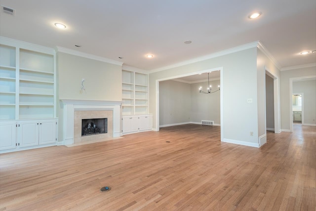 1060 Island Dr, Memphis, TN 38103 - unfurnished living room featuring built in features, a chandelier, baseboards, light wood-type flooring, and crown molding