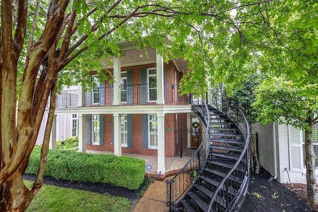 1060 Island Dr, Memphis, TN 38103 - view of front of property with brick siding, stairway, and a porch