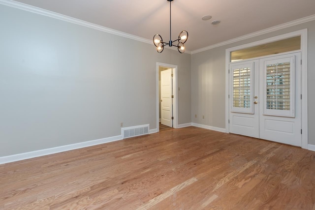 1060 Island Dr, Memphis, TN 38103 - unfurnished room featuring ornamental molding, a chandelier, light wood-style floors, french doors, and baseboards