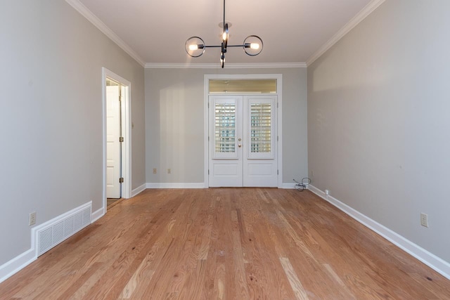 1060 Island Dr, Memphis, TN 38103 - unfurnished dining area featuring crown molding, a chandelier, baseboards, and light wood finished floors