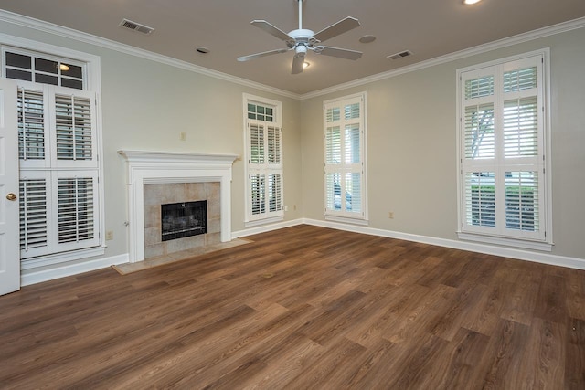 1060 Island Dr, Memphis, TN 38103 - unfurnished living room featuring wood finished floors, a ceiling fan, baseboards, crown molding, and a tiled fireplace