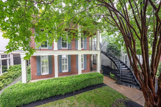 1060 Island Dr, Memphis, TN 38103 - multi unit property featuring a porch, stairs, and brick siding