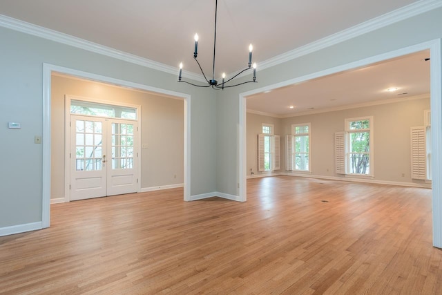 1060 Island Dr, Memphis, TN 38103 - unfurnished room featuring a chandelier, light wood-style flooring, baseboards, and crown molding