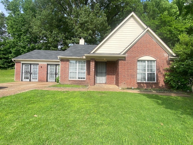 4335 Grand Cedar Ln N, Memphis, TN 38128 - view of front facade featuring brick siding, a chimney, and a front lawn