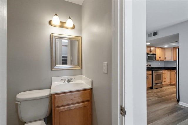 1829 Eagle Branch Cv Unit 41, Germantown, TN 38138 - bathroom featuring wood finished floors, vanity, toilet, and baseboards