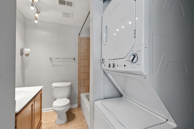 1829 Eagle Branch Cv Unit 41, Germantown, TN 38138 - full bath featuring stacked washer / dryer, vanity, tile patterned floors, toilet, and shower / tub combination