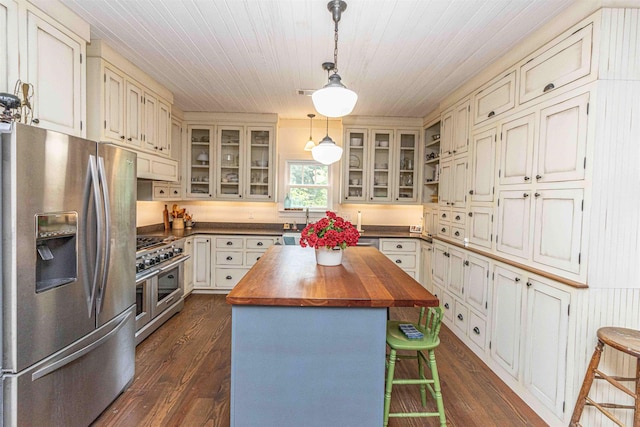 504 Rushing Rd, Michie, TN 38357 - kitchen featuring stainless steel appliances, wooden counters, dark wood finished floors, a breakfast bar area, and wooden ceiling