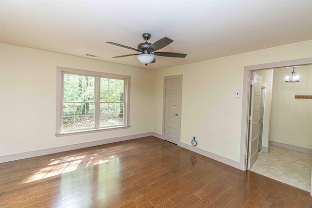 504 Rushing Rd, Michie, TN 38357 - unfurnished room featuring wood finished floors, ceiling fan, baseboards, and a chandelier