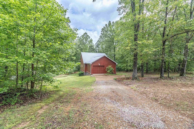 504 Rushing Rd, Michie, TN 38357 - view of front of home with driveway, an outdoor structure, a wooded view, and a detached garage
