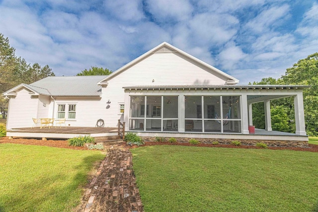 504 Rushing Rd, Michie, TN 38357 - back of property with a sunroom, a lawn, a deck, and metal roof