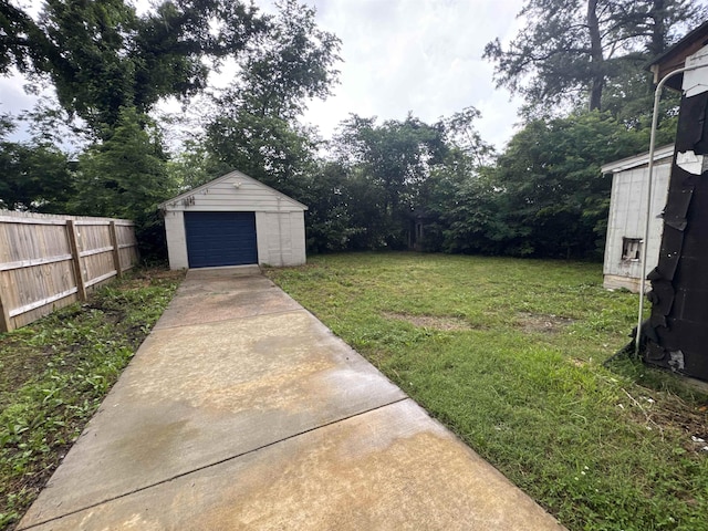 411 Hodges St, Memphis, TN 38111 - view of yard with concrete driveway, a garage, and an outdoor structure