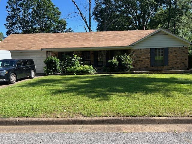 4155 Sevella Rd, Memphis, TN 38128 - ranch-style home with a garage, a front yard, and brick siding