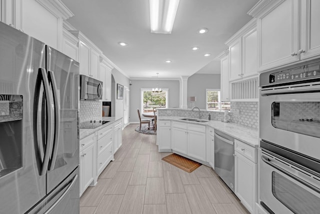 546 Township Cv, Collierville, TN 38017 - kitchen featuring appliances with stainless steel finishes, a sink, recessed lighting, a chandelier, and tasteful backsplash