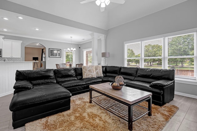 546 Township Cv, Collierville, TN 38017 - living room featuring plenty of natural light, ceiling fan, arched walkways, ornamental molding, and a chandelier