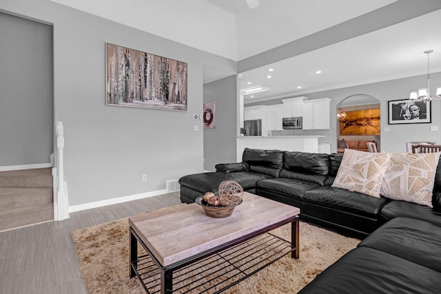 546 Township Cv, Collierville, TN 38017 - living room with arched walkways, a chandelier, recessed lighting, wood finished floors, and baseboards