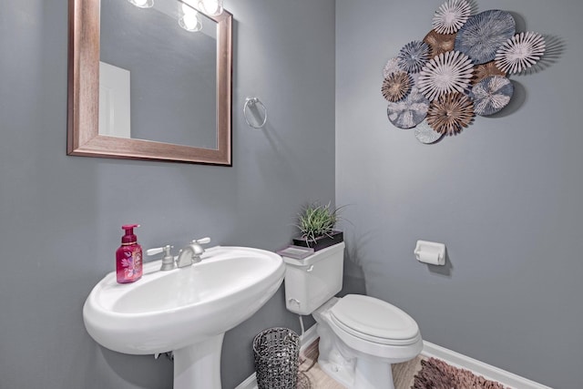 546 Township Cv, Collierville, TN 38017 - half bathroom with baseboards, toilet, and a sink
