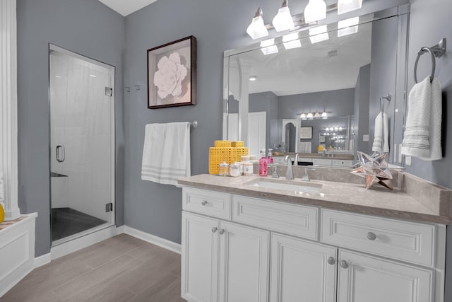 546 Township Cv, Collierville, TN 38017 - bathroom featuring a stall shower, vanity, wood finished floors, and baseboards