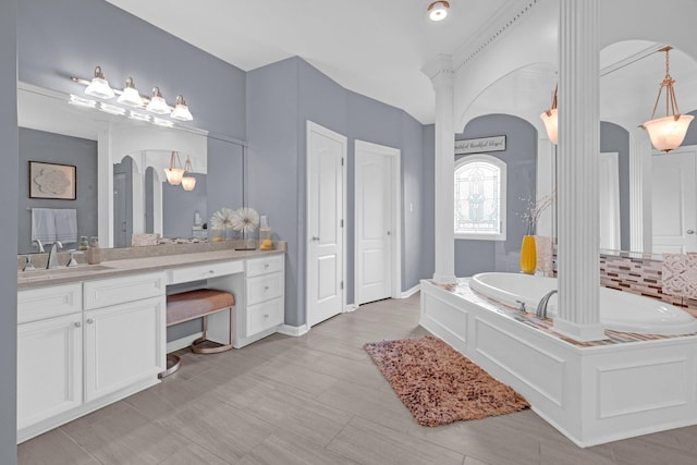 546 Township Cv, Collierville, TN 38017 - full bathroom with a bath, vanity, ornate columns, and tasteful backsplash