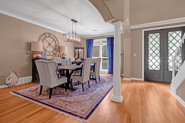 546 Township Cv, Collierville, TN 38017 - dining space featuring ornate columns, baseboards, wood finished floors, ornamental molding, and a chandelier