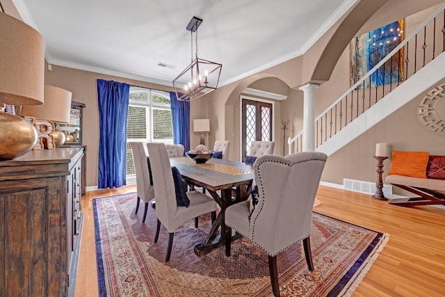 546 Township Cv, Collierville, TN 38017 - dining room with arched walkways, wood finished floors, healthy amount of natural light, and crown molding