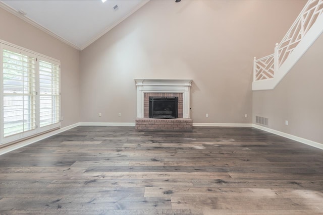 1625 Autumn Tree Cv, Memphis, TN 38016 - unfurnished living room featuring crown molding, wood finished floors, a fireplace, baseboards, and high vaulted ceiling