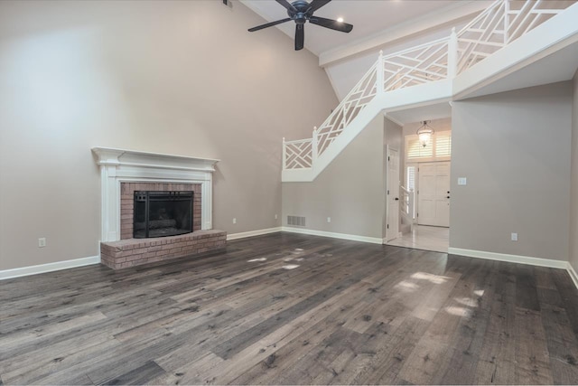 1625 Autumn Tree Cv, Memphis, TN 38016 - unfurnished living room with high vaulted ceiling, ceiling fan, baseboards, and wood finished floors