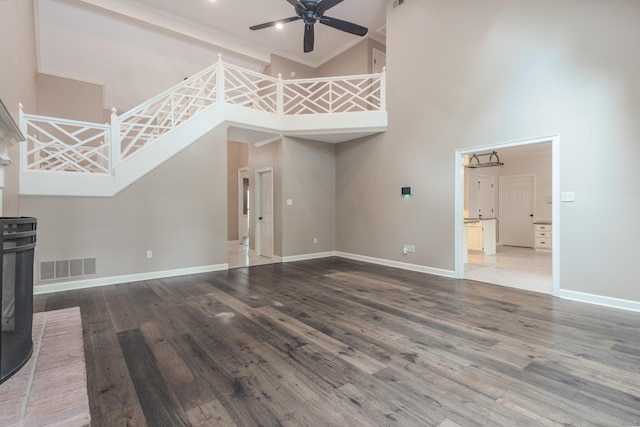 1625 Autumn Tree Cv, Memphis, TN 38016 - unfurnished living room with a towering ceiling, ceiling fan, baseboards, wood finished floors, and crown molding