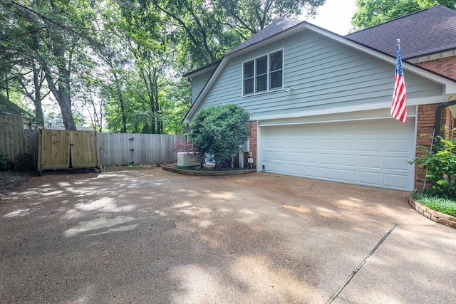 1625 Autumn Tree Cv, Memphis, TN 38016 - view of property exterior with brick siding, asphalt driveway, a garage, and a shingled roof
