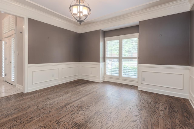 1625 Autumn Tree Cv, Memphis, TN 38016 - empty room with a chandelier, a wainscoted wall, crown molding, and wood finished floors