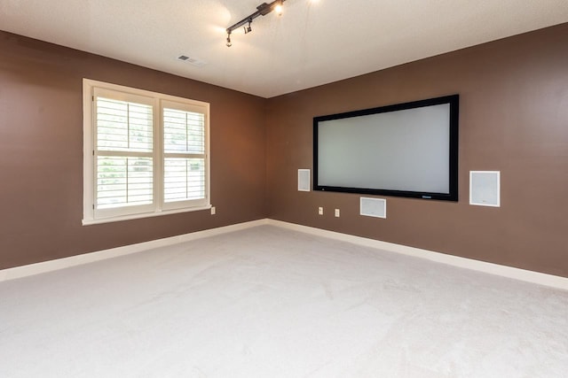 1625 Autumn Tree Cv, Memphis, TN 38016 - carpeted home theater room featuring track lighting and baseboards