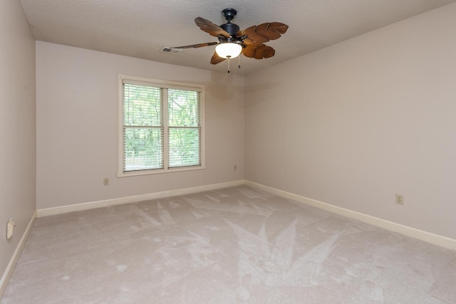 1625 Autumn Tree Cv, Memphis, TN 38016 - spare room with light colored carpet, baseboards, ceiling fan, and a textured ceiling