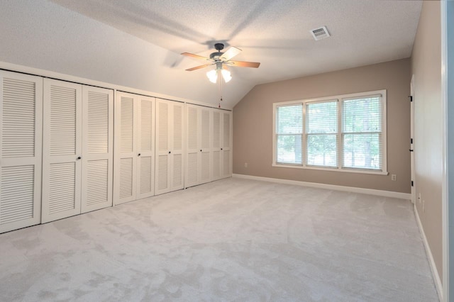 1625 Autumn Tree Cv, Memphis, TN 38016 - unfurnished bedroom with baseboards, lofted ceiling, carpet flooring, a textured ceiling, and a ceiling fan