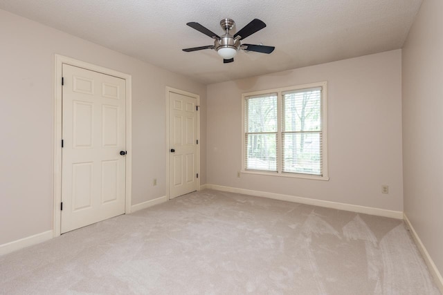 1625 Autumn Tree Cv, Memphis, TN 38016 - unfurnished bedroom featuring light carpet, baseboards, and a textured ceiling