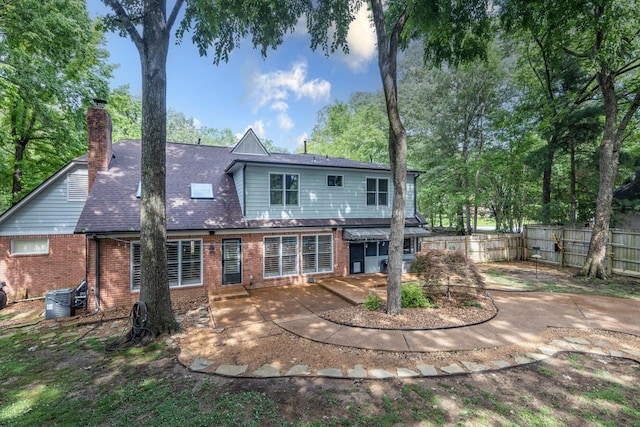 1625 Autumn Tree Cv, Memphis, TN 38016 - rear view of property featuring brick siding, a patio, a chimney, and central air condition unit
