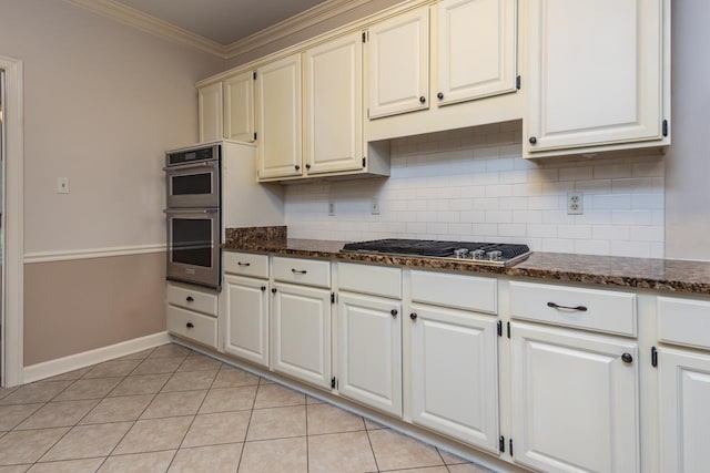 1625 Autumn Tree Cv, Memphis, TN 38016 - kitchen featuring appliances with stainless steel finishes, tasteful backsplash, ornamental molding, dark stone countertops, and light tile patterned floors