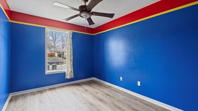 6861 Sauterne Cv, Memphis, TN 38115 - spare room with a ceiling fan, wood finished floors, a textured ceiling, and baseboards