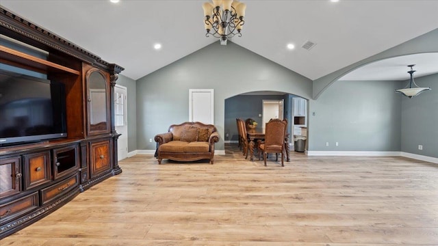 6861 Sauterne Cv, Memphis, TN 38115 - sitting room featuring arched walkways, a chandelier, light wood-type flooring, lofted ceiling, and baseboards