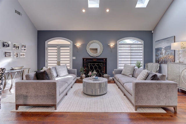 6703 N Kirby Oaks Cv, Memphis, TN 38119 - living area featuring a skylight, high vaulted ceiling, wood finished floors, recessed lighting, and a high end fireplace