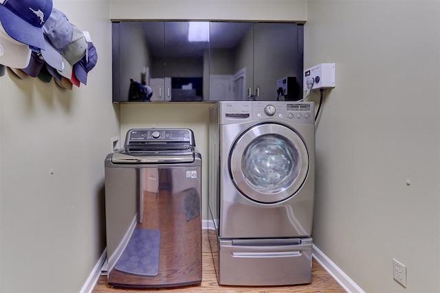 6703 N Kirby Oaks Cv, Memphis, TN 38119 - washroom with washer and clothes dryer, baseboards, and wood finished floors