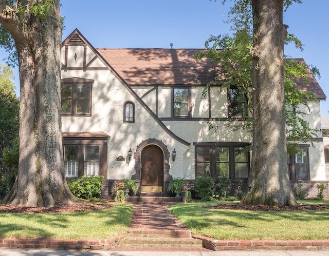 1514 Vance Ave, Memphis, TN 38104 - tudor home with stucco siding, a front yard, and roof with shingles