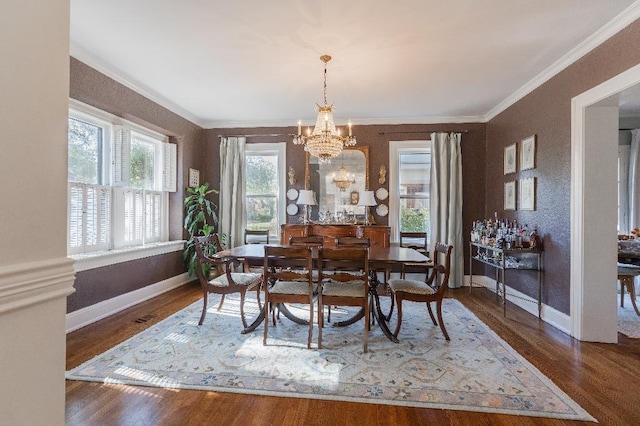 1514 Vance Ave, Memphis, TN 38104 - dining area with a chandelier, crown molding, baseboards, and wood finished floors