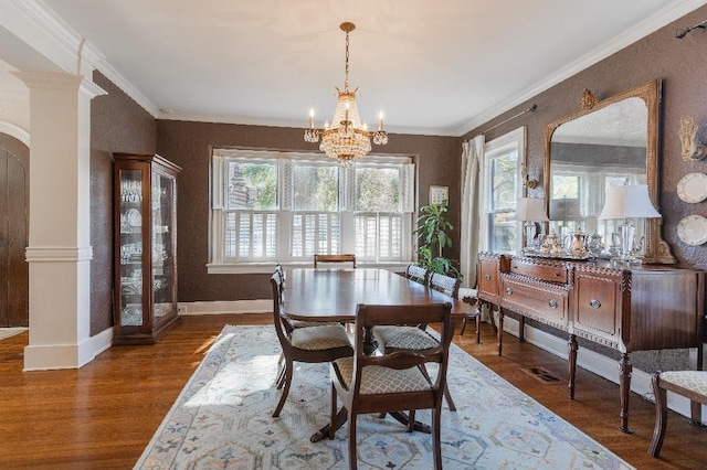 1514 Vance Ave, Memphis, TN 38104 - dining area featuring a chandelier, wood finished floors, baseboards, ornate columns, and crown molding