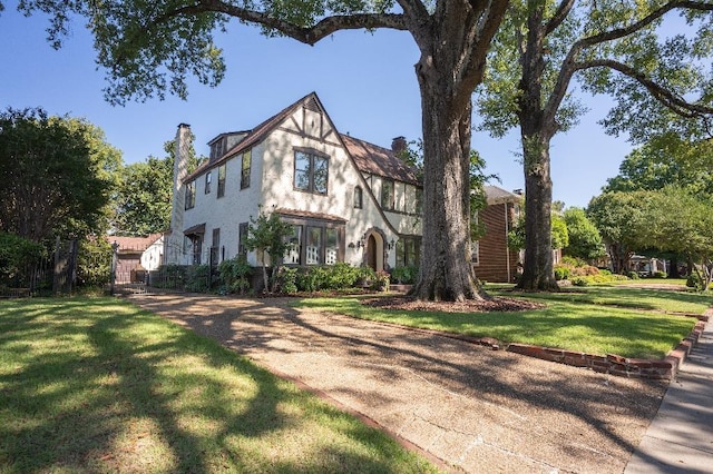 1514 Vance Ave, Memphis, TN 38104 - english style home with a chimney, a front lawn, and stucco siding