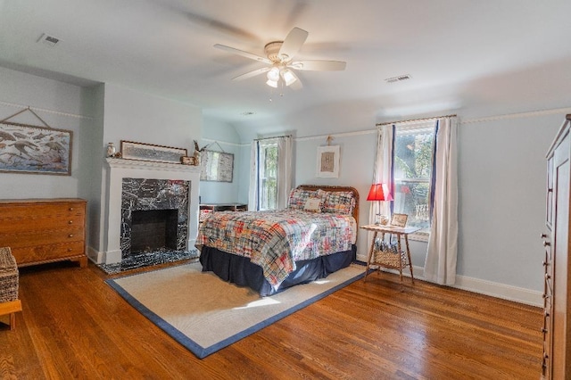 1514 Vance Ave, Memphis, TN 38104 - bedroom with wood finished floors, a premium fireplace, a ceiling fan, and baseboards