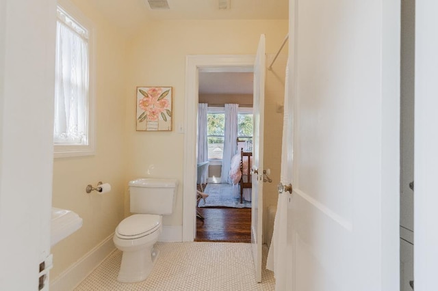 1514 Vance Ave, Memphis, TN 38104 - bathroom with toilet, baseboards, and tile patterned flooring