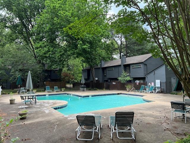 3970 Grahamdale Cir Unit 3970A, Memphis, TN 38122 - community pool with a patio area and view of wooded area